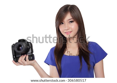 Beautiful girl with nice smile look at the camera while holding DSLR camera, isolated on white background