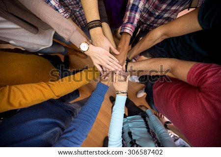 Unit and concord in multiethnic team, all hands together  Royalty-Free Stock Photo #306587402