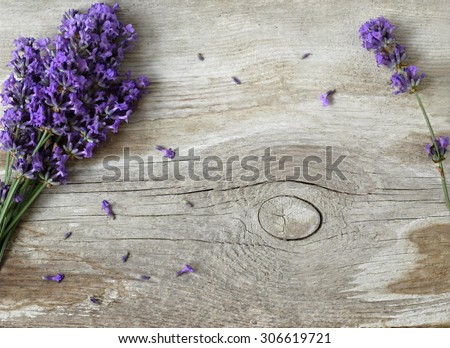 Bunch of lavender flowers on a wooden background. Floral border or frame with lavender.