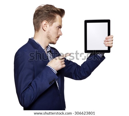 Studio shot of a young man pointing at digital tablet. Isolated on white background. 