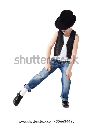 Little boy in jeans and hat is dancing on white