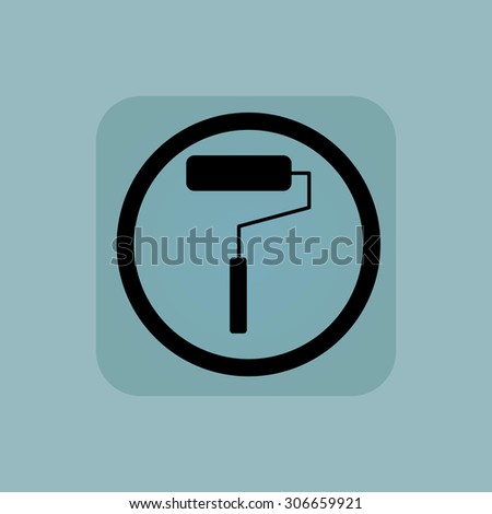 Paint roller in circle, in square, on pale blue background