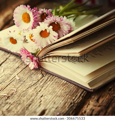 Vintage books with bouquet of flowers/ nostalgic vintage background