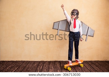 Portrait of young businessman with toy paper wings. Success, creative and start up concept. Copy space for your text Royalty-Free Stock Photo #306713030