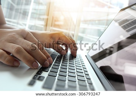 Double exposure of business man hand working on blank screen laptop computer on wooden desk as concept Royalty-Free Stock Photo #306793247