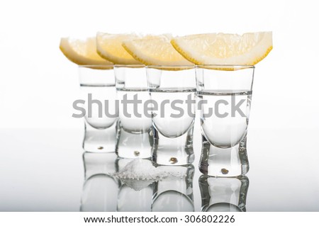 Photo of four shots of vodka with lemon