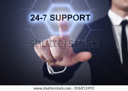 Businessman pressing button on touch screen interface and select "24-7 support". Business concept. Internet concept.