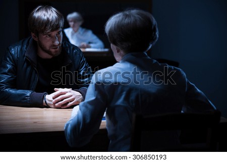 Picture of police interrogation in a dark room
