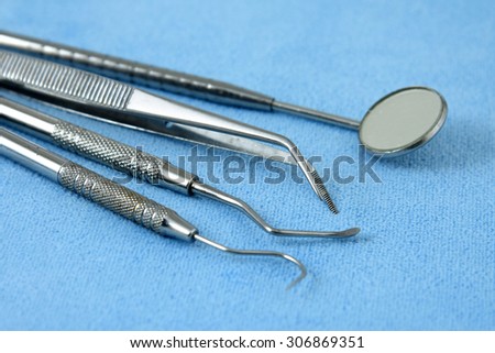 Dental tools at clinic isolated on blue table
