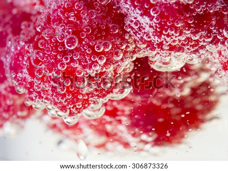 Sparkling berries. An image of fresh raspberries in champagne. It creates a lovely bubbly effect on the berries.