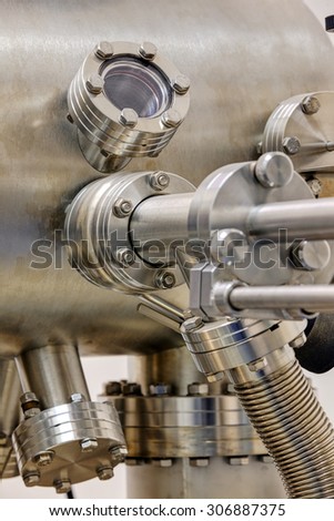 Detail of stainless steel machinery in physics laboratory Royalty-Free Stock Photo #306887375