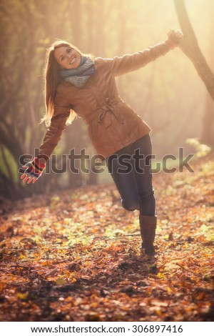 Autumn fashion, young women hiking in the forest, sunset in the background, with color filters, soft focus effect, and some fine film grain added to the picture 