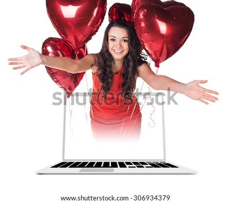A gorgeous businesswoman looks out of the laptop