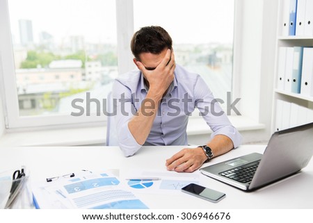 business, people, fail, paperwork and technology concept - businessman with laptop computer and papers working in office Royalty-Free Stock Photo #306946676