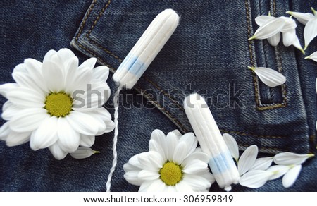 panty liners and tampons on jeans background