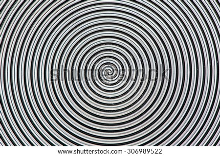 Metal surface with spiral texture closeup photo background.