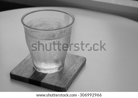 Glass of water cold with laptop computer working business on the table in the office. Natural beverage the best start to any morning about communication service contact in the restaurant or cafe.