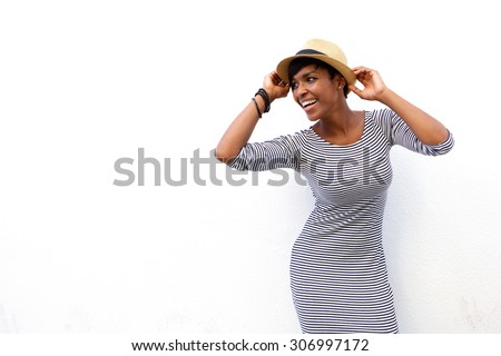 Portrait of an attractive black woman smiling with hat against white background 