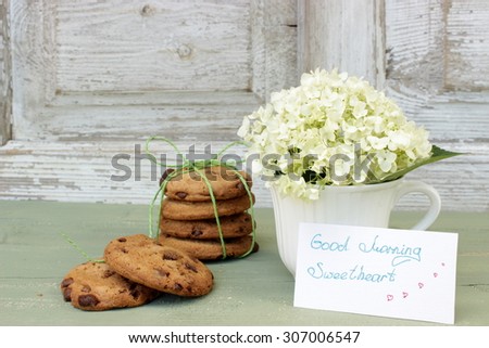 Composition with cookies and flowers in a cup with message