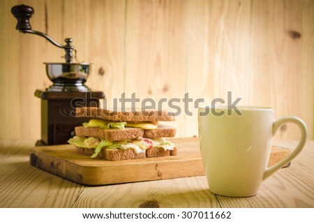 
Sandwiches and a cup of tea in wooden 