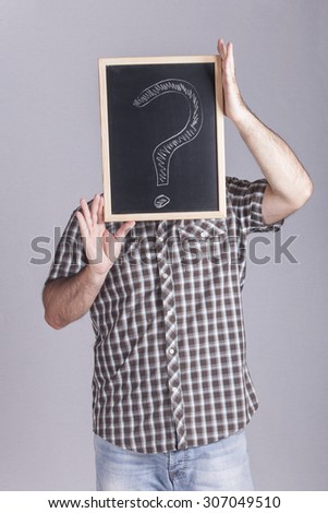 Man holding a blackboard with a question mark