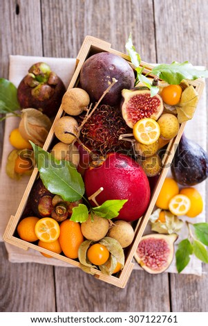 Variety of exotic fruits in a wooden crate Royalty-Free Stock Photo #307122761