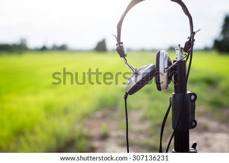 One earphone at green field in thailand