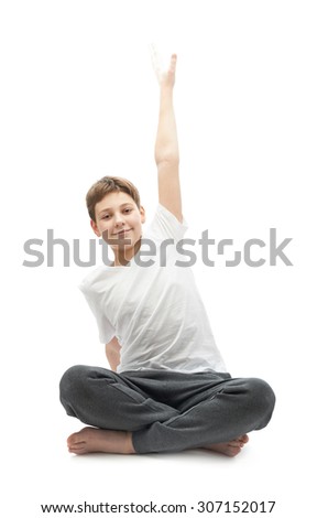 Caucasian 12 years old childen boy in a white t-shirt stretching or doing yoga. Composition isolated over the white background