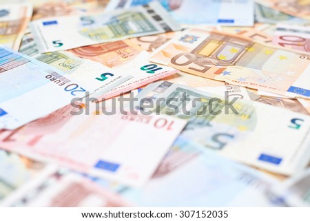 Surface covered with multilpe euro bank note bills as a background composition with the shallow depth of field