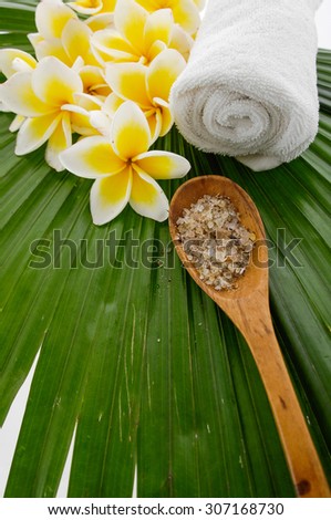  frangipani with towel, salt in spoon , towel , on palm leaf
