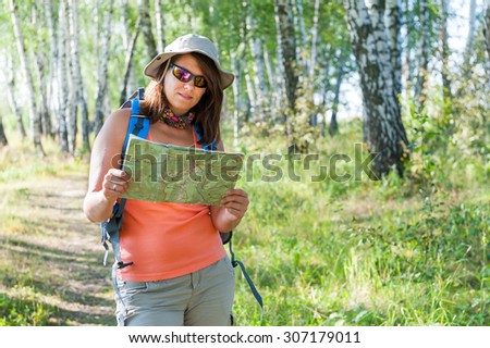 Young woman exploring the trekking map
