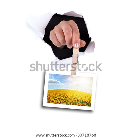 woman hands holding clip thru white wall hole