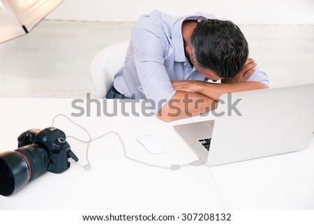 Photographer sleeping at his workplace in studio