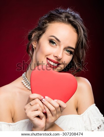Beauty young girl with Valentine heart in her hands