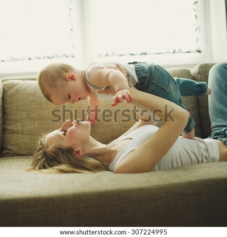 beautiful young mother with baby at home