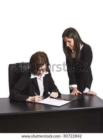 Two businesswomen signing a contract in the office. All the documents are mine.