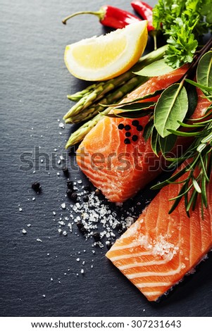 Delicious  portion of fresh salmon fillet  with aromatic herbs, spices and vegetables - healthy food, diet or cooking concept