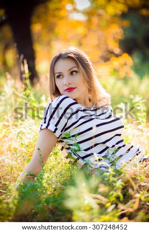 woman sitting on yellow grass in the park