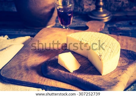 Vintage photo of still life with french goat cheese. Studio shoot with mystic light effect.