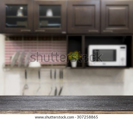 Wooden table for present product on kitchen blur background
