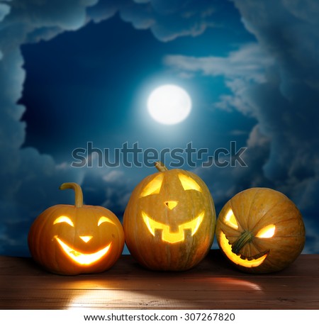 Scary halloween pumpkins on a wooden table