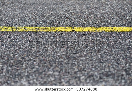 Detail of asphalt road with yellow line