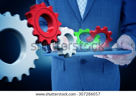 Close up view of businessman using tablet computer against blue background with vignette