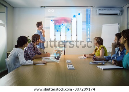 Percentages graphical representation against attentive business team following a presentation Royalty-Free Stock Photo #307289174