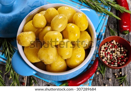 Potatoes cooked in a ceramic dish on a wooden surface