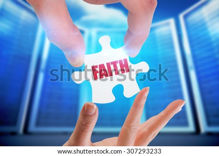 The word faith and hands holding jigsaw against composite image of server room