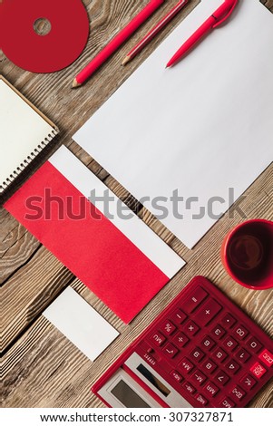 The mockup on wooden background with red calculator