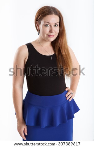 Evoke young woman in blue skirt and black top, looking at camera, isolated on white background