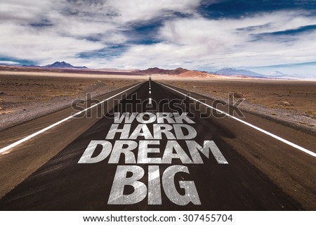 Work Hard Dream Big written on desert road Royalty-Free Stock Photo #307455704
