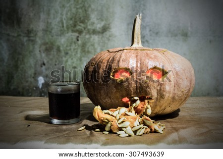 Haunted carved pumpkins for Halloween with liqueur
